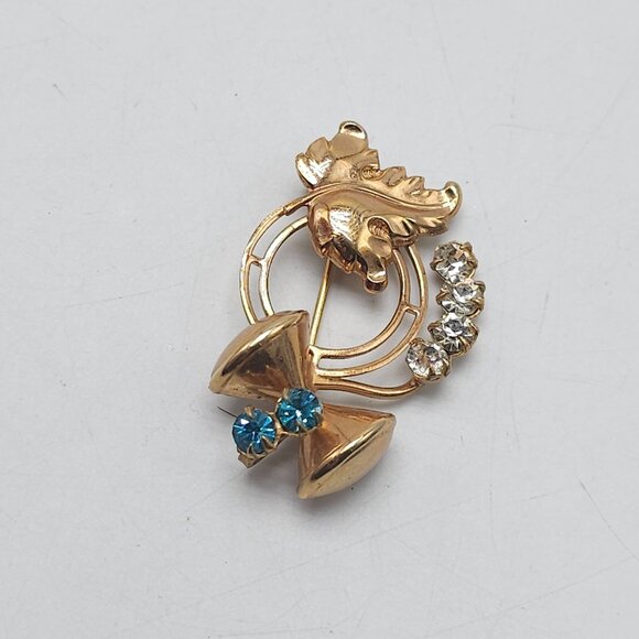 Vintage Gold Tone Brooch With Blue Clear Rhinestones Bow Leaf Design - Picture 2 of 4